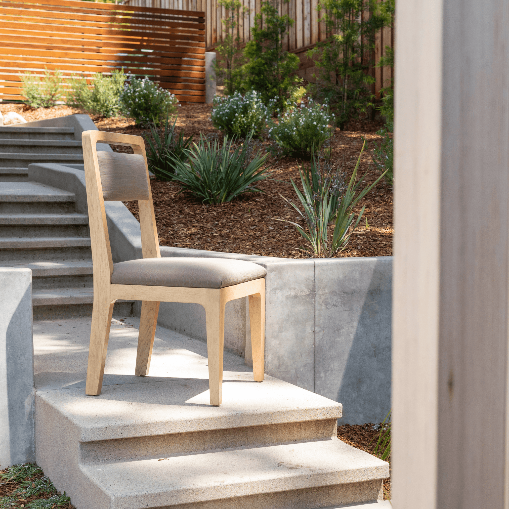 Ashley Yeates, renowned interior designer and sustainable leader, presenting her elegant Caroline chair, crafted from eco-friendly materials, embodying modern style and sustainable living