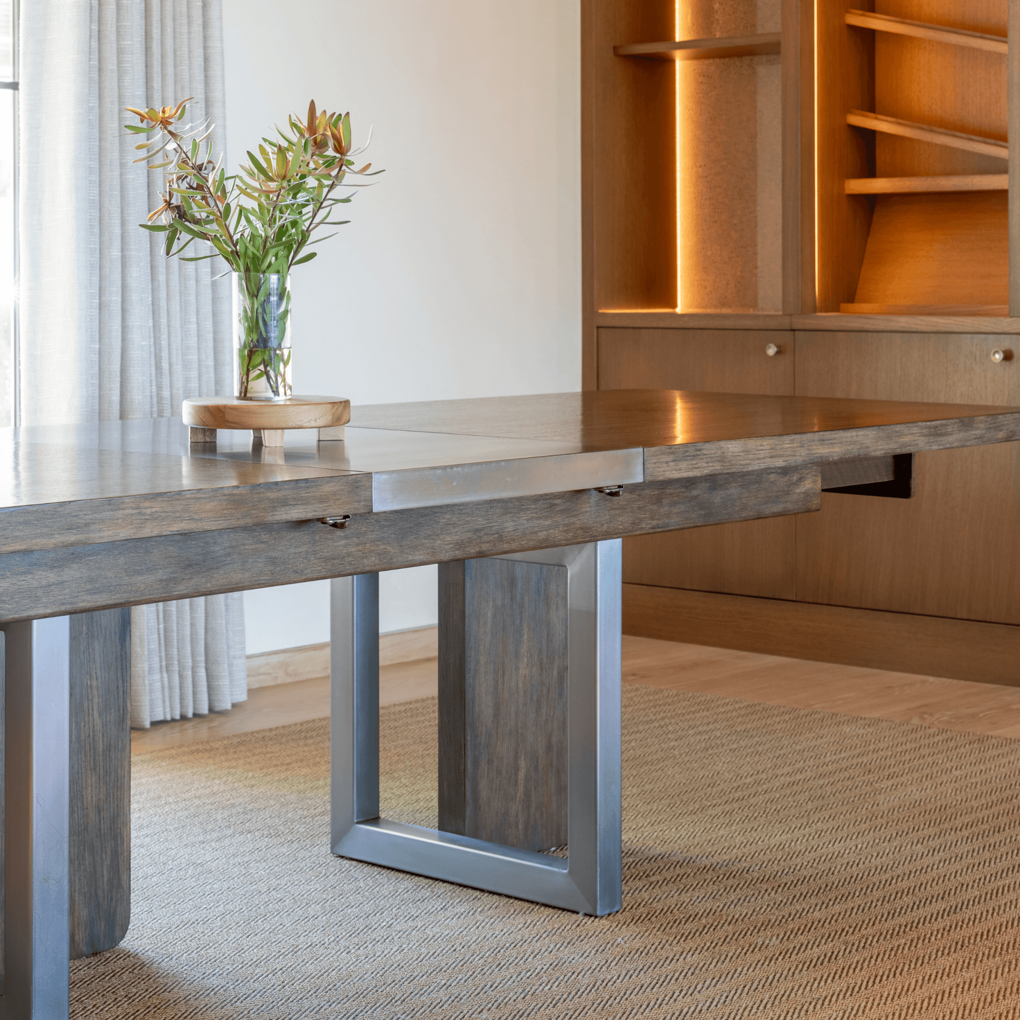 Ashley Yeates, renowned interior designer and sustainable leader, showcasing the Grant Dining Table, a stunning piece crafted from eco-friendly materials that exemplifies sustainable luxury in modern dining